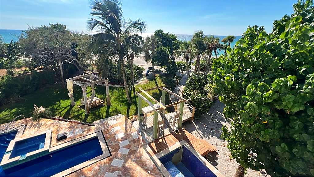 View from the balcony over the pools, gardens, palms and the Gulf of Mexico