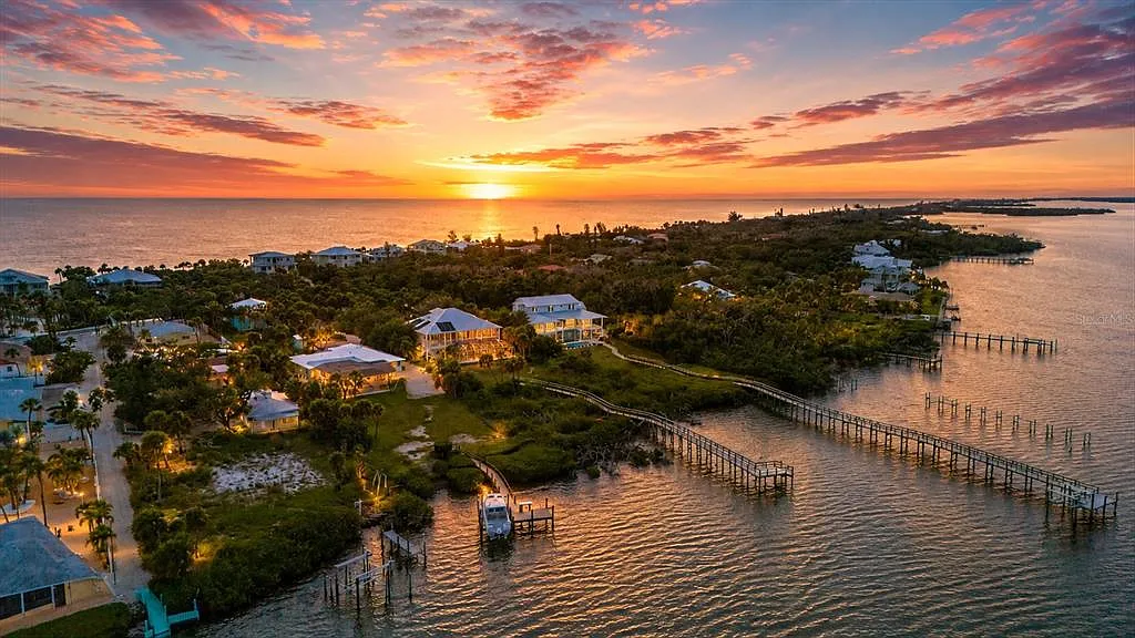 Lemon Bay at sunset with the private dock and boat lift — bayside compound across Manasota Key Road