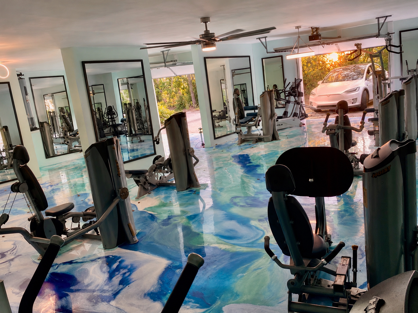 Gym interior with floor-to-ceiling mirror walls and art epoxy floor